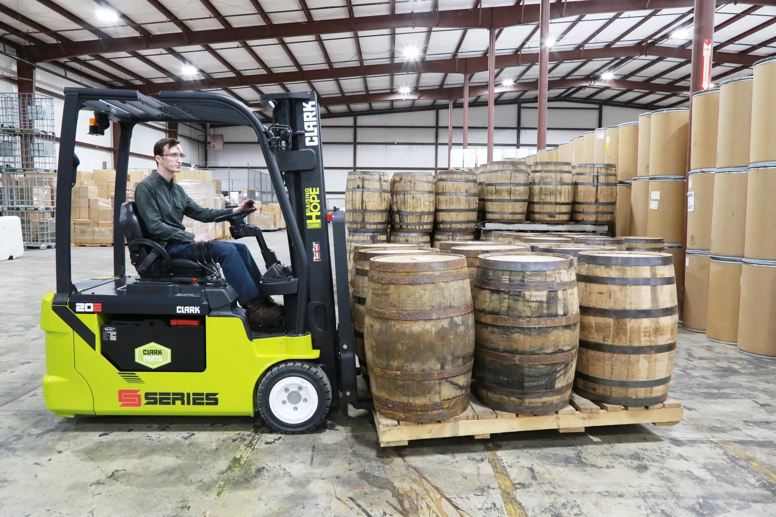 Electric forklift moving barrels in a Central PA warehouse