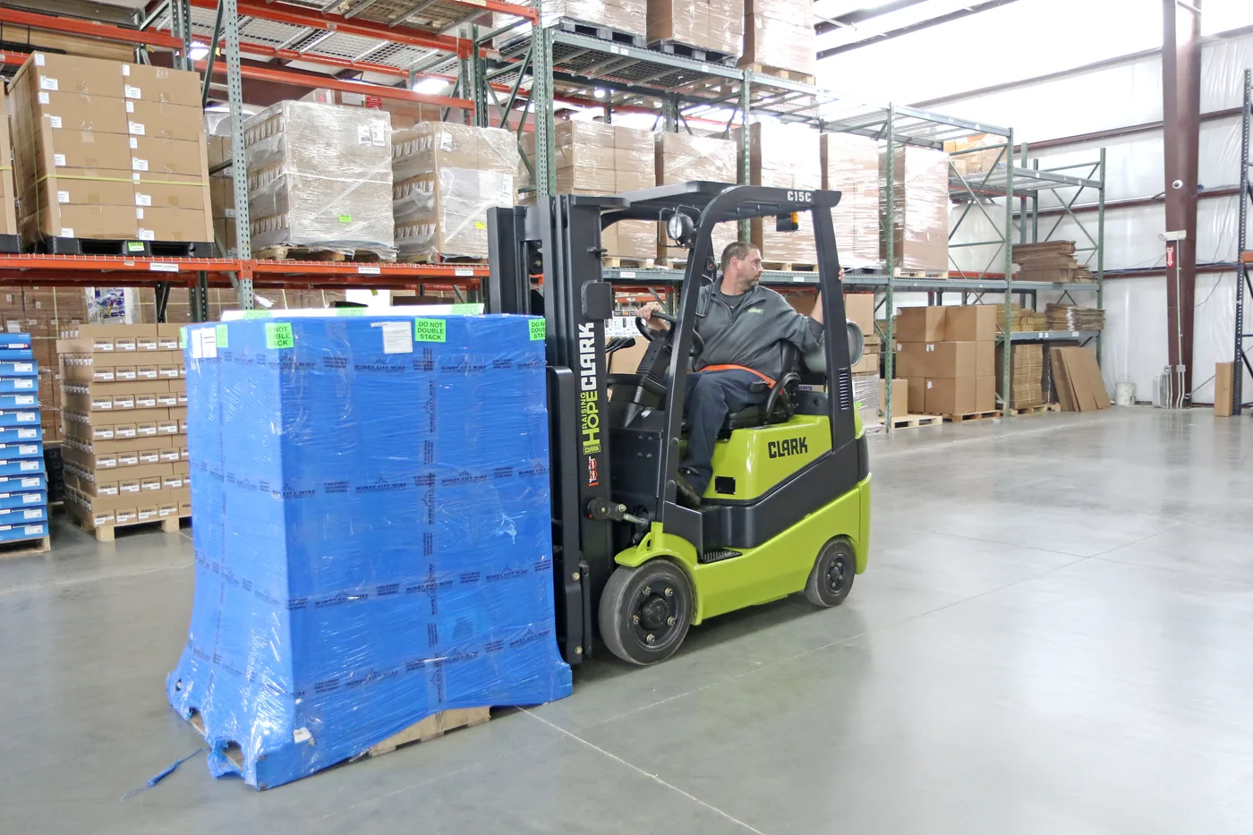 Used Clark cushion tire forklift moving a pallet in a Central PA warehouse